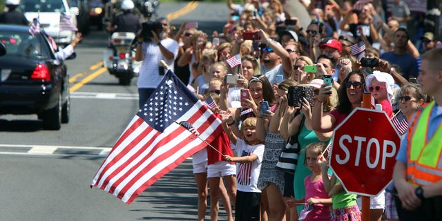 People wave and hold flags during a parade for Olympic gymnast Laurie Hernandez on Saturday, Aug. 27, 2016, in Old Bridge, N.J. (Magdeline Bassett/The Asbury Park Press via AP)