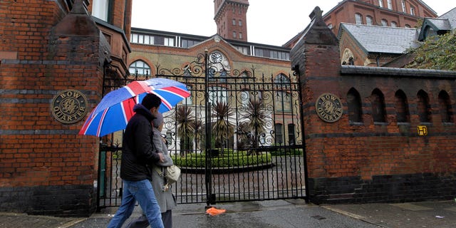 File - In this file photo dated Sunday, April 29, 2012 shows people walk past gated residential flats in Bow, east London, where the Ministry of Defence have warned residents that surface-to-air missiles could be stationed on their rooftops during the London Olympics. The British military plans to deploy surface-to-air missiles at six sites around London as part of security measures for the July 27- Aug. 12 games. The layer of the residents of the 17-story Fred Wigg Tower in Leytonstone, east London, told the High Court on Monday, July 9, 2012 that residents fear the missiles could make the building a terrorist target. (AP Photo/Sang Tan,File)