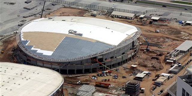FILE - In this Oct. 9, 2015, file aerial photo, construction continues at the Rio Olympics velodrome in Rio de Janeiro. The president of cyclings world governing body remains very, very concerned that the velodrome under construction for the Rio Olympics will not be completed by the opening in August. (AP Photo/David J. Phillip, File)
