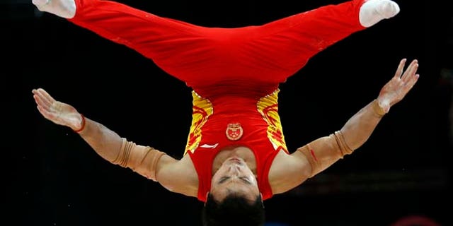 July 30, 2012: Chinese gymnast Feng Zhe performs on the parallel bars during the Artistic Gymnastic men's team final at the 2012 Summer Olympics, in London.