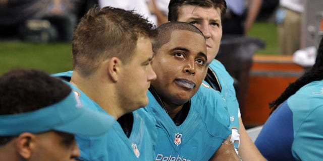 Sept. 30, 2013: Miami Dolphins guard Richie Incognito (68), center left, and tackle Jonathan Martin (71), center right, sit on the bench in the second half of an NFL football game against the New Orleans Saints in New Orleans. (AP)