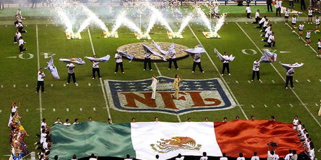 FILE - In this Oct. 2, 2005, file photo, performers are shown prior to the start of a regular season NFL game between the Arizona Cardinals and San Francisco 49ers at Azteca Stadium in Mexico City, Mexico. Eleven years after the network telecast an NFL game from Mexico City, it will do so again when the Raiders "host" the Texans on Monday night. (AP Photo/Marco Ugargte, File)