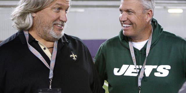 FILE - In this April 9, 2014, file photo, New Orleans Saints defensive coordinator Rob Ryan, left, and New York Jets head coach Rex Ryan talk to each other during NFL football pro day in Baton Rouge, La. The Ryan twins are best known for their defensive acumen. After four weeks, they are looking defenseless. Rex's Jets are 1-3, have lost three in a row and can't cover anyone in the passing game. Rob's Saints, he's the defensive coordinator under coach Sean Payton, have been even worse than Rex's bunch. (AP Photo/Jonathan Bachman, File)
