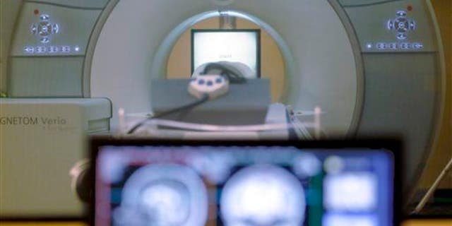 A brain-scanning MRI machine is shown.