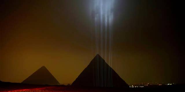 The Giza pyramids are backlit ahead of a New Year's Eve fireworks display near Cairo on Dec. 31, 2015.