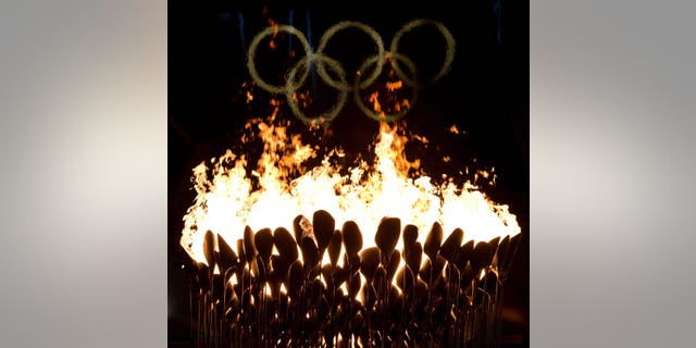 The Olympic cauldron burns following the opening ceremonies to the 2012 Summer Olympics in London on Saturday, July 28, 2012. (AP Photo/The Canadian Press, Sean Kilpatrick)