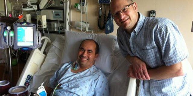 This June, 2014 photo shows Ernie Balcueva, in bed, who received a heart transplant 15 years ago and is again hoping for a new heart.