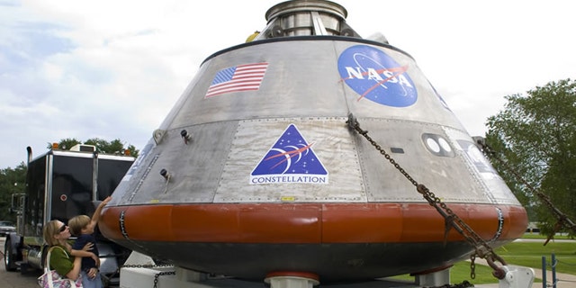 Visitors view a full-scale mockup of NASA's Orion crew exploration vehicle during its one-day display August 12 at StenniSphere, the visitor center at John C. Stennis Space Center. President Obama will announce plans to salvage the Orion module from the overbudget Constellation program in a speech Thursday.