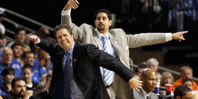 TAMPA, FL - MARCH 19: (L-R) Head coach John Calipari and assistant coach Orlando Antigua of the Kentucky Wildcats react as they coach against the West Virginia Mountaineers during the third round of the 2011 NCAA men's basketball tournament at St. Pete Times Forum on March 19, 2011 in Tampa, Florida. (Photo by J. Meric/Getty Images) *** Local Caption *** John Calipari; Orlando Antigua