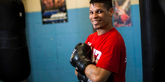 Boxer Orlando Cruz poses for pictures after a training session at a public gym in San Juan, Puerto Rico, Oct. 4, 2012.