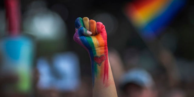 LOS ANGELES, CA - JUNE 13: A defiant fist is raised at a vigil for the worst mass shooing in United States history on June 13, 2016 in Los Angeles, United States. A gunman killed 49 people and wounded 53 others at a gay nightclub in Orlando, Florida early yesterday morning before suspect Omar Mateen also died on-scene. (Photo by David McNew/Getty Images)