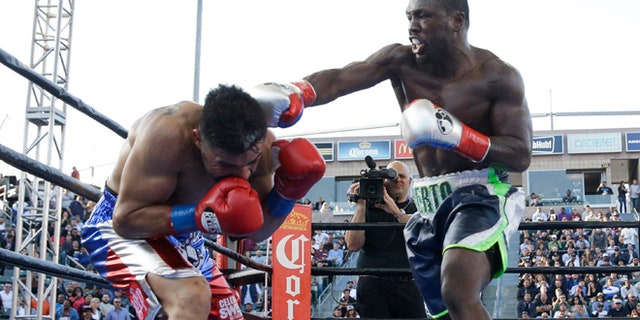 Andre Berto, right, lands a punch to Victor Ortiz during the fourth round of a welterweight boxing match, Saturday, April 30, 2016, in Carson, Calif. Berto won by knockout in the fourth round. (AP Photo/Jae C. Hong)