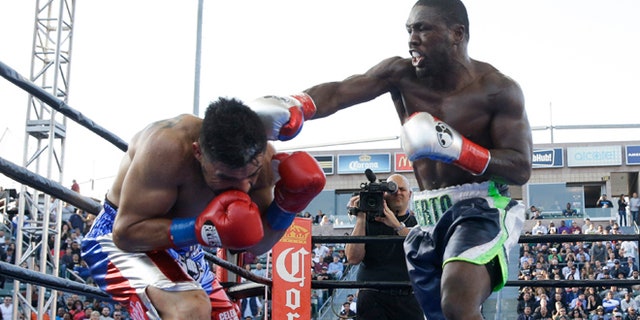 Andre Berto, right, lands a punch to Victor Ortiz during the fourth round of a welterweight boxing match, Saturday, April 30, 2016, in Carson, Calif. Berto won by knockout in the fourth round. (AP Photo/Jae C. Hong)
