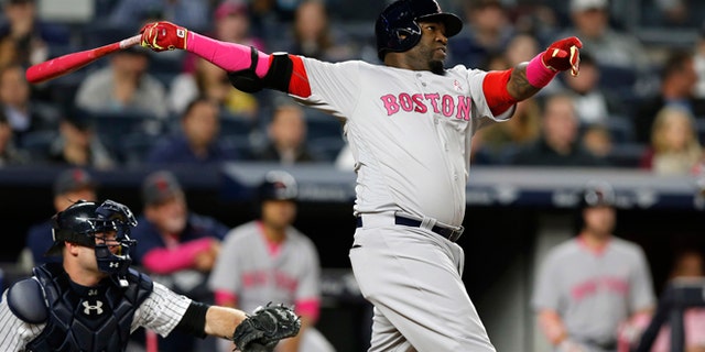 Boston Red Sox designated hitter David Ortiz watches his fourth-inning, solo home run off New York Yankees starting pitcher Luis Severino in a baseball game against the New York Yankees at Yankee Stadium in New York, Sunday, May 8, 2016. Severino also gave up a first-inning, two-run home run to the Red Sox Dustin Pedroia. New York Yankees catcher Brian McCann watches fro behind Ortiz. (AP Photo/Kathy Willens)