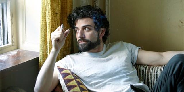 This film image released by CBS FIlms shows Oscar Isaac in a scene from "Inside Llewyn Davis." Isaac was nominated for a Golden Globe for best actor in a motion picture musical or comedy for his role in the film on Thursday, Dec. 12, 2013. The 71st annual Golden Globes will air on Sunday, Jan. 12. (AP Photo/CBS FIlms, Alison Rosa)