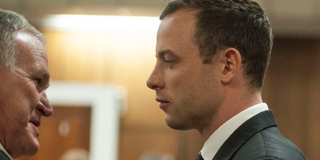 June 30, 2014: Oscar Pistorius listens to his lawyer Barry Roux, left, in court in Pretoria, South Africa.
