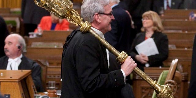 FILE In this March 25, 2011 file photo, Sergeant-at-Arms Kevin Vickers carries the mace from the House of Commons at the conclusion of the session in Ottawa. (AP Photo/The Canadian Press,Adrian Wyld)