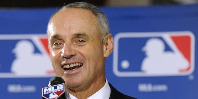 FILE - In this Aug. 14, 2014, file phhoto, Major League Baseball Chief Operating Officer Rob Manfred speaks to reporters after team owners elected him as the next commissioner of Major League Baseball  in Baltimore. Baseball owners voted Thursday, Nov. 20, 2014, to give him a five-year term as commissioner when he succeeds Bud Selig in two months.  (AP Photo/Steve Ruark, File)