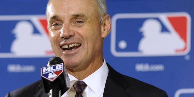 FILE - In this Aug. 14, 2014, file phhoto, Major League Baseball Chief Operating Officer Rob Manfred speaks to reporters after team owners elected him as the next commissioner of Major League Baseball in Baltimore. Baseball owners voted Thursday, Nov. 20, 2014, to give him a five-year term as commissioner when he succeeds Bud Selig in two months. (AP Photo/Steve Ruark, File)