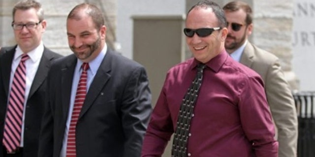 Former Scott Twp. Police Chief James Romano, right, leaves the Lackawanna County Courthouse on Monday.