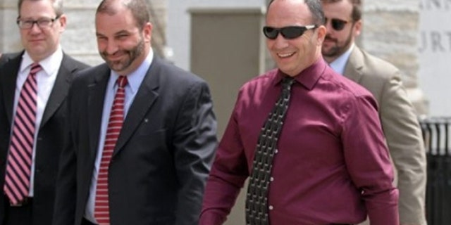 Former Scott Twp. Police Chief James Romano, right, leaves the Lackawanna County Courthouse on Monday.