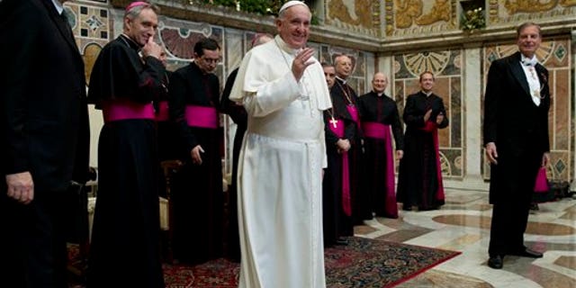 Pope Francis meets ambassadors to the Holy See, at the Vatican, Monday, Jan. 13, 2014. Pope Francis on Monday criticized abortion as evidence of a "throwaway culture" that wastes people as well as food, saying such a mentality is a threat to world peace. Francis also urged better respect for migrants and denounced the persecution of Christians in Asia, Africa and the Middle East in his global survey of world crises delivered to diplomats accredited to the Holy See. (AP Photo/Andrew Medichini, Pool)
