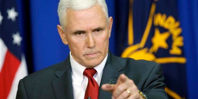 Indiana Gov. Mike Pence takes a question during a news conference, Tuesday, March 31, 2015, in Indianapolis. (AP Photo/Darron Cummings)