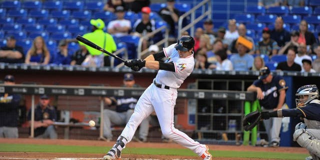 Miami Marlins left fielder Christian Yelich flies out during the first inning of a baseball game against the Milwaukee Brewers.