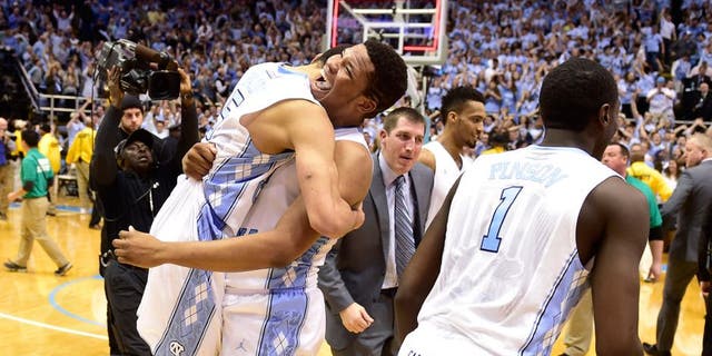 Jan 10, 2015; Chapel Hill, NC, USA; North Carolina Tar Heels guard/forward Theo Pinson (1) and guard Marcus Paige (5) and forward Kennedy Meeks (3) react after the game. The Tar Heels defeated the Cardinals 72-71 at Dean E. Smith Center. Mandatory Credit: Bob Donnan-USA TODAY Sports