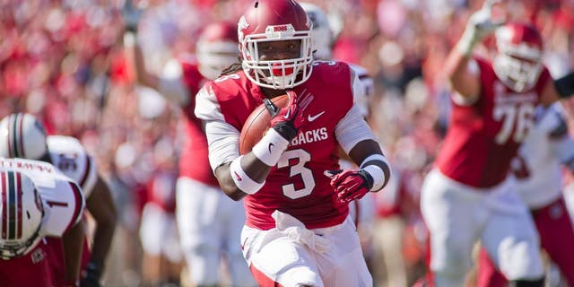 Oct 12, 2013; Fayetteville, AR, USA; Arkansas Razorbacks running back Alex Collins (3) runs with the ball during a game against the South Carolina Gamecocks at Donald W. Reynolds Razorback Stadium. South Carolina defeated Arkansas 52-7. Mandatory Credit: Beth Hall-USA TODAY Sports