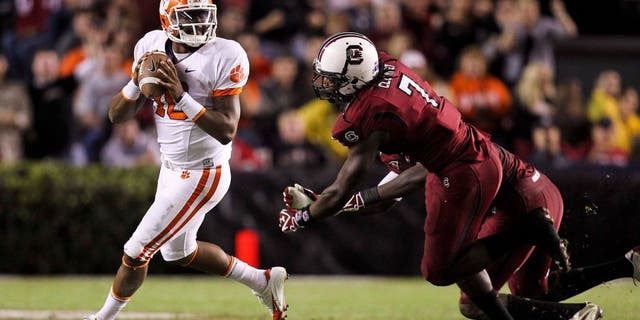 November 26, 2011; Columbia, SC, USA; Clemson Tigers quarterback Tajh Boyd (10) scrambles away from South Carolina Gamecocks defensive end Jadeveon Clowney (7) in the third quarter of the game at the Williams-Brice Stadium. The Gamecocks beat the Tigers 34-13. Mandatory Credit: Daniel Shirey-USA TODAY Sports