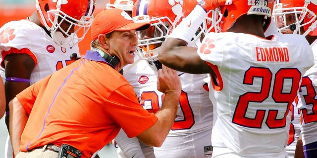 Oct 24, 2015; Miami Gardens, FL, USA; Clemson Tigers head coach Dabo Swinney talks with his players during the first half against the Miami Hurricanes at Sun Life Stadium. Mandatory Credit: Steve Mitchell-USA TODAY Sports