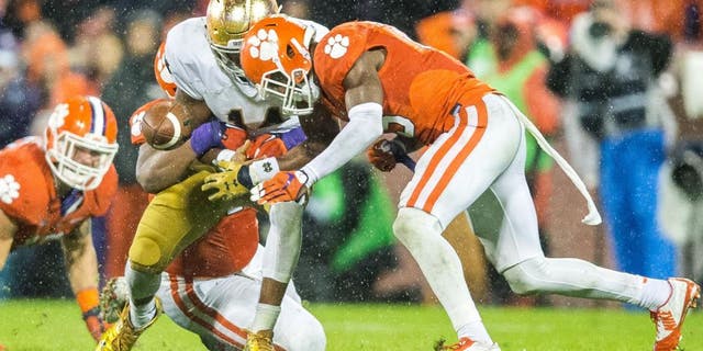 Oct 3, 2015; Clemson, SC, USA; Notre Dame Fighting Irish quarterback DeShone Kizer (14) fumbles as he is hit by Clemson Tigers safety T.J. Green (15) in the fourth quarter at Clemson Memorial Stadium. Clemson won 24-22. Mandatory Credit: Matt Cashore-USA TODAY Sports