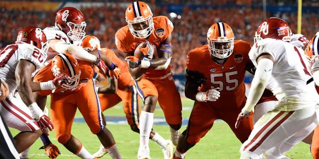 Dec 31, 2015; Miami Gardens, FL, USA; Clemson Tigers running back Wayne Gallman (9) runs in to the end zone to score a touchdown against the Oklahoma Sooners in the third quarter of the 2015 CFP Semifinal at the Orange Bowl at Sun Life Stadium. Mandatory Credit: John David Mercer-USA TODAY Sports