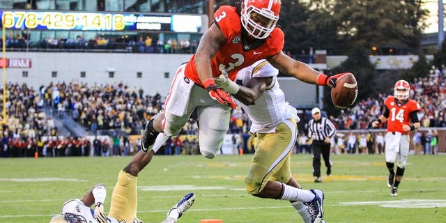 Nov 30, 2013; Atlanta, GA, USA; Georgia Bulldogs running back Todd Gurley (3) dives into the end zone for a touchdown over Georgia Tech Yellow Jackets cornerback D.J. White (28) and linebacker Brandon Watts (11) in the first half at Bobby Dodd Stadium. Mandatory Credit: Daniel Shirey-USA TODAY Sports