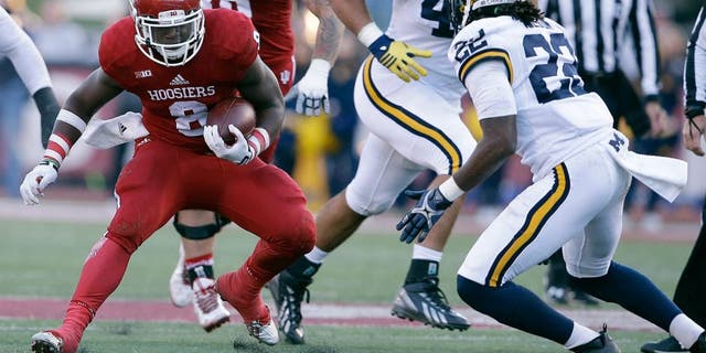 Indiana's Jordan Howard (8) runs against Michigan's Jarrod Wilson (22) during the first half of an NCAA college football game Saturday, Nov. 14, 2015, in Bloomington, Ind. (AP Photo/Darron Cummings)