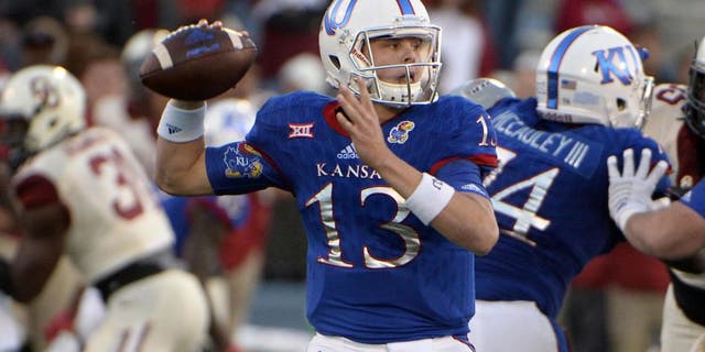 Oct 31, 2015; Lawrence, KS, USA; Kansas Jayhawks quarterback Ryan Willis (13) throws a pass against the Oklahoma Sooners in the second half at Memorial Stadium. Oklahoma won the game 62-7. Mandatory Credit: John Rieger-USA TODAY Sports