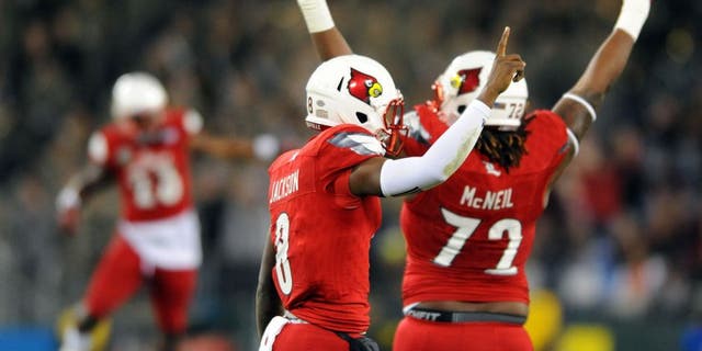 Dec 30, 2015; Nashville, TN, USA; Louisville Cardinals quarterback Lamar Jackson (8) celebrates after a 62-yard touchdown run during the first half against the Texas A&M Aggies in the 2015 Music City Bowl at Nissan Stadium. Mandatory Credit: Christopher Hanewinckel-USA TODAY Sports