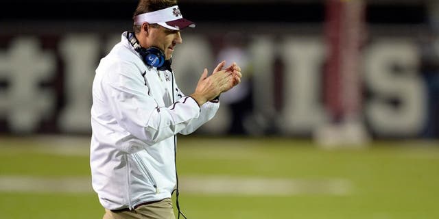 Nov 16, 2013; Starkville, MS, USA; Mississippi State Bulldogs head coach Dan Mullen cheers on hs players following a series of downs against the Alabama Crimson Tide during the first quarter at Davis Wade Stadium. Mandatory Credit: John David Mercer-USA TODAY Sports