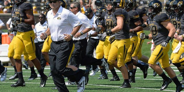 Sep 7, 2013; Columbia, MO, USA; Missouri Tigers head coach Gary Pinkel leads his team off the field prior to the game between the Missouri Tigers and the Toledo Rockets at Faurot Field. Mandatory Credit: Jasen Vinlove-USA TODAY Sports