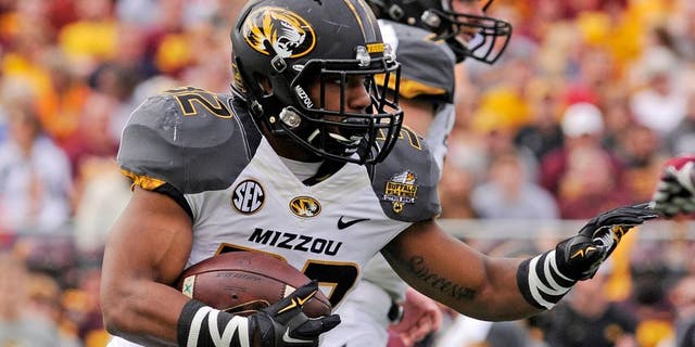 Jan 1, 2015; Orlando, FL, USA; Missouri Tigers running back Russell Hansbrough (32) runs the ball against the Minnesota Golden Gophers in the first quarter of the 2015 Citrus Bowl at Florida Citrus Bowl. Mandatory Credit: David Manning-USA TODAY Sports