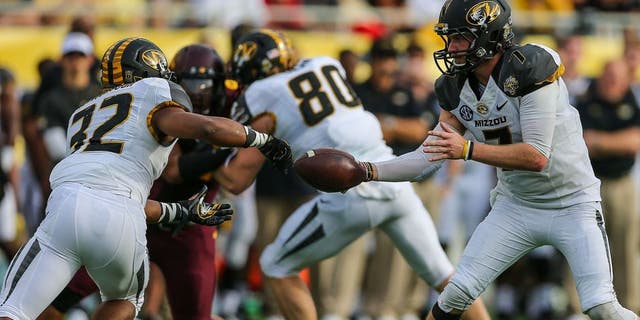 Jan 1, 2015; Orlando, FL, USA; Missouri Tigers quarterback Maty Mauk (7) hands off to running back Russell Hansbrough (32) during the second half in the 2015 Citrus Bowl at Florida Citrus Bowl. Missouri wins 33-17 over Minnesota. Mandatory Credit: Jim Dedmon-USA TODAY Sports