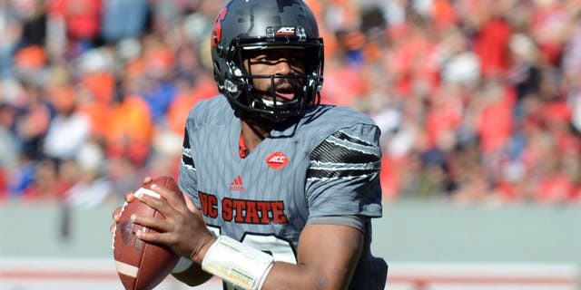 Nov 21, 2015; Raleigh, NC, USA; North Carolina State Wolfpack quarterback Jacoby Brissett (12) looks to pass during the first half against the Syracuse Orange at Carter Finley Stadium. Mandatory Credit: Rob Kinnan-USA TODAY Sports