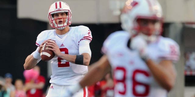 Wisconsin Badgers quarterback Joel Stave rolls out on the final drive of the game against the Nebraska Cornhuskers at Memorial Stadium in Lincoln, Neb., on Saturday, Oct. 10, 2015. Wisconsin won 23-21.