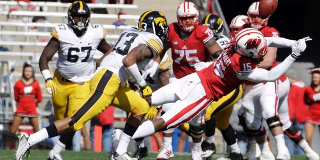 Wisconsin's Robert Wheelwright can't hang onto a pass in front of Iowa's Greg Mabin during the first half of an NCAA college football game in Madison, Wis., on Saturday, Oct. 3, 2015.