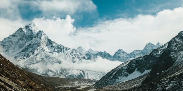 PHERICHE, NEPAL, FEBRUARY 13, 2015: The peak of Ama Dablam (6812m) is seen above the village of Pheriche and the Dudh Kosi river vallery, in the Solu-Khumbu region of Nepal, February 13, 2015. The Solu-Khumbu region is home to the world's highest mountain, Mount Everest (8848m). According to leading researchers, in recent years the landscape and people of the Solu-Khumbu region have come under increasing pressure from raising temperatures and shifting climactic conditions. As well as being home to many of the world's highest mountains, the region holds some of the world's largest and highest glaciers, some of which have begun to show signs of increased and rapid melt. The Khumbu glacier, which lies at the foot of Mount Everest, has in the last decade begun to develop ponds of water on its surface, which scientists say could develop into a much larger lake on the glacierâs surface if warming trends continue. Recent research indicates that annual mean surface temperature in the Himalaya has increased by 1.5 degrees celsius over pre-industrial temperatures. (Photo by Ed Giles/Getty Images).
