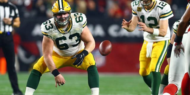Jan 16, 2016; Glendale, AZ, USA; Green Bay Packers center Corey Linsley (63) snaps the ball to quarterback Aaron Rodgers (12) against the Arizona Cardinals in the first quarter of a NFC Divisional round playoff game at University of Phoenix Stadium. Mandatory Credit: Mark J. Rebilas-USA TODAY Sports
