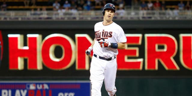Minnesota Twins' Joe Mauer rounds the bases on his solo home run off Kansas City Royals starting pitcher Ian Kennedy.