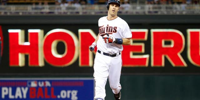 Minnesota Twins' Joe Mauer rounds the bases on his solo home run off Kansas City Royals starting pitcher Ian Kennedy.