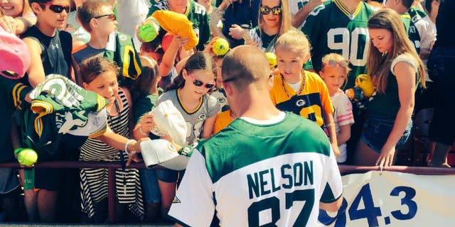 Green Bay Packers receiver Jordy Nelson signs autographs after his annual charity softball game.